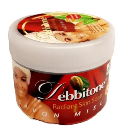 savon Debbitone Radiant Skin Soap, un savon noir à base de plantes et souvent enrichi au miel.